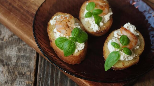 Crostini with cream cheese, shrimp and fresh basil. Tasty healthy snacks.
