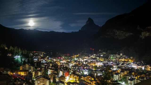 Cinematic night timelapse featuring Zermatt, the Matterhorn and a bright moon over the Swiss Alps