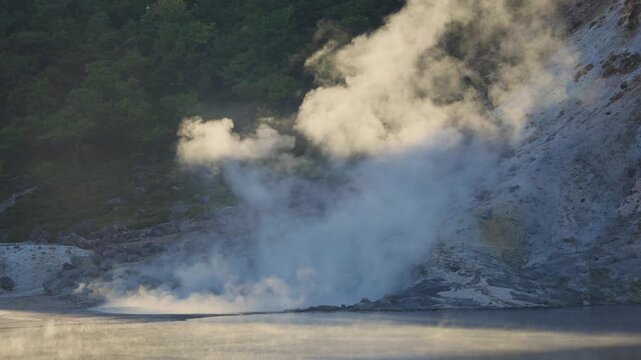 Geothermal activity with hot steam and sulfurous gases rising from volcanic vents in Jigokudani, also known as Hell Valley, a famous hot spring area within the Shikotsu Toya National Park