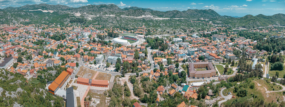 Cetinje historic city, Montenegro, featuring its famous monastery, National Museum, and surrounding mountains under a blue sky