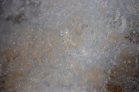 Water splashing with droplets and white foam in motion