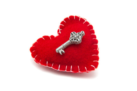 Red heart and key on the white background