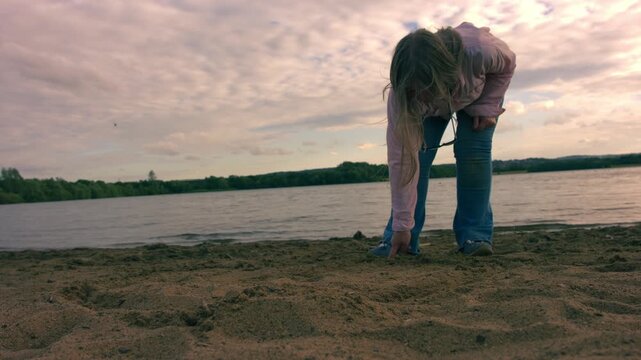 Woman drawing a line in the sand at beach