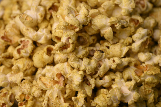 Extreme Macro Background Of Golden Seasoned Popcorn With Crispy Texture
