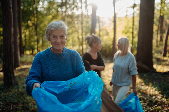 Senior women volunteering for nature protection and litter collection.