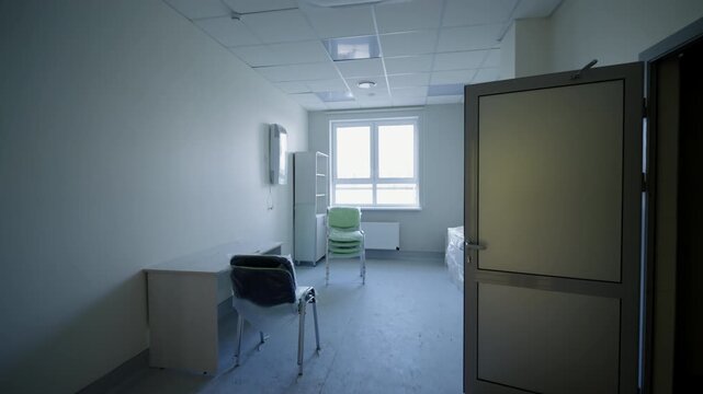 Medical workspace undergoes final renovation process with protective plastic on chairs. Pristine minimalist facility layout looks spacious