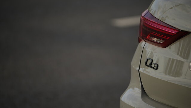 Rear view detail of Audi Q3 vehicle showing automotive design, brand logo and modern car styling on urban street