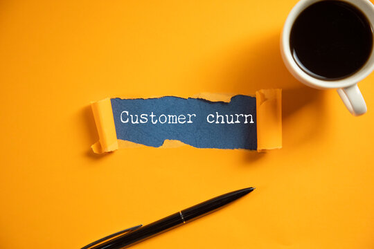 Businessman holds in hands a card with the name of the customer churn.