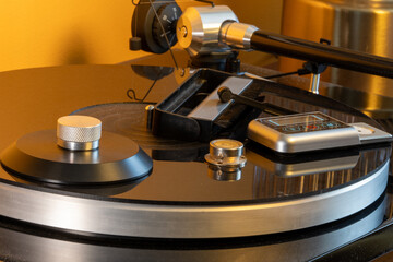 Record turntable vinyl player accessories showing a collection of brushes, scales, level, record clamp and spike feet. © alexander