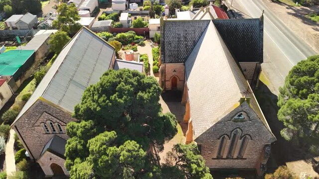 St Peter's Anglican Church, Moonta, Yorke Peninsula, South Australia &ndash; 4K aerial drone view of historic heritage church, Gothic architecture, Copper Coast, reidential houses, estates