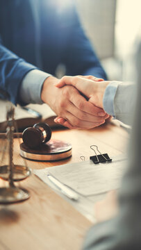 Business partners shaking hands after a legal agreement
