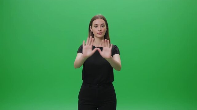 Woman's hands demonstrating sign language gesture against green screen with cinematic motion