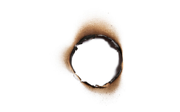 A circular burn hole in paper isolated on transparent background