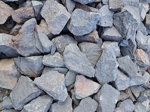 Crushed stone rocks texture background, coarse gravel aggregate and crushed basalt for road construction and civil engineering.