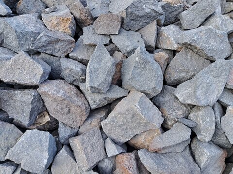 Crushed stone rocks texture background, coarse gravel aggregate and crushed basalt for road construction and civil engineering.