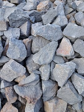 Crushed stone rocks texture background, coarse gravel aggregate and crushed basalt for road construction and civil engineering.