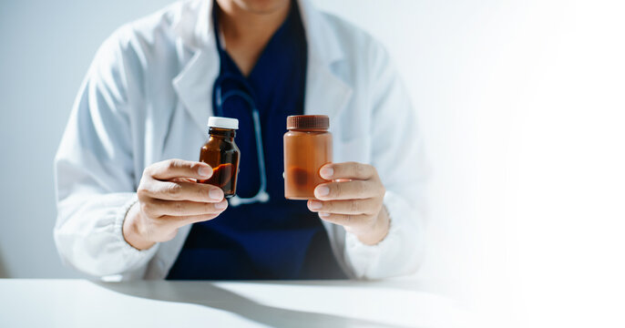 A healthcare professional holding and explaining a prescription medicine bottle.