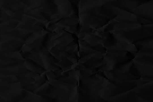 Silhouette of the number 46 formed by creases on a dark crumpled paper surface forty-six shape