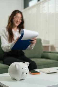 woman sitting at desk managing expenses, calculating expenses, paying bills using laptop online, making household financial analysis, Save money to future It is the concept of provident fund.