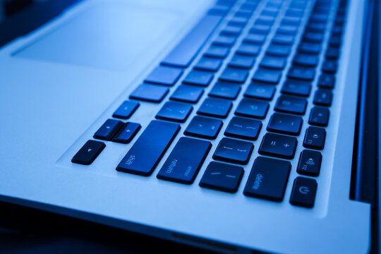 Close up detail of modern laptop keyboard, computer technology and typing concept