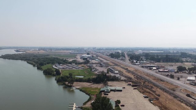 Aerial of industrial and commercial area by Snake River in Cassia County Idaho with extensive railroad tracks and Interstate 84