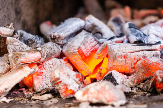 Glowing Embers and Hot Coals of a Burning Wood Fire Close-Up With Ash and Charcoal