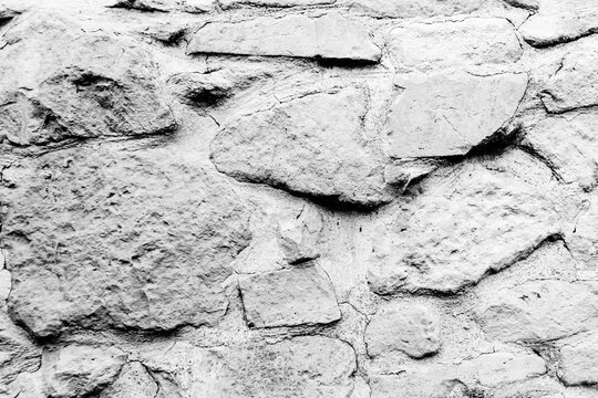 Rough Stone Wall Texture With Weathered Masonry Surface in Black and White Closeup