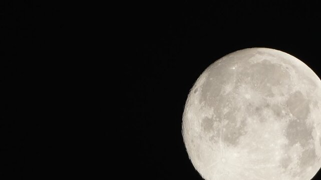 Moon astronomy space capturing a detailed view of the lunar surface with craters and highlights against the pitch black night sky