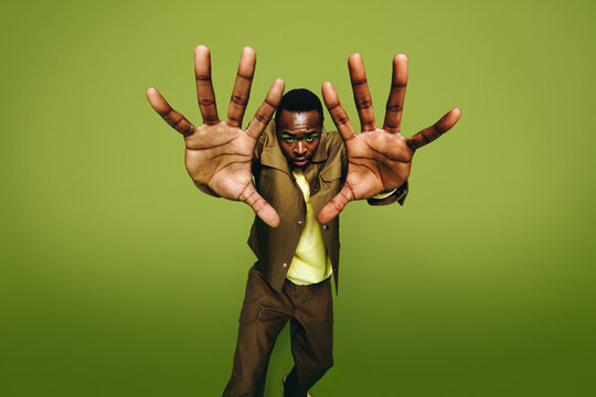 Dynamic urban portrait of a man with bold fashion style in studio