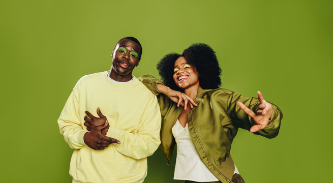 Duo of friends dances together in the studio with playful urban attitude
