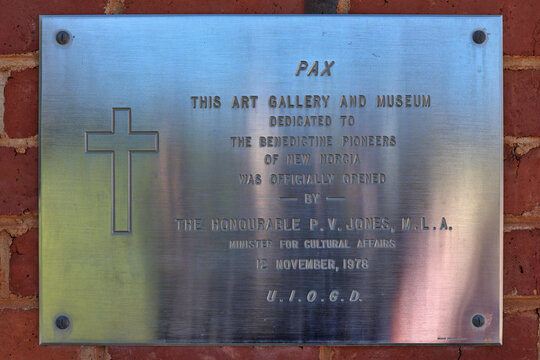 New Norcia, Western Australia, Australia - May 31 2026: Stainless steel plaque on brick wall, the art gallery and museum. Australia's only monastic town. Heritage, history, travel and tourism
