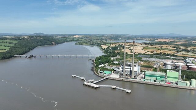 Industrial power generation facility overlooking the River Suir estuary, County Wexford, Ireland, filmed from a smooth cinematic drone flight.