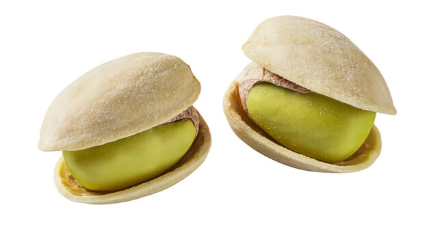 Two open pistachios with bright green kernels