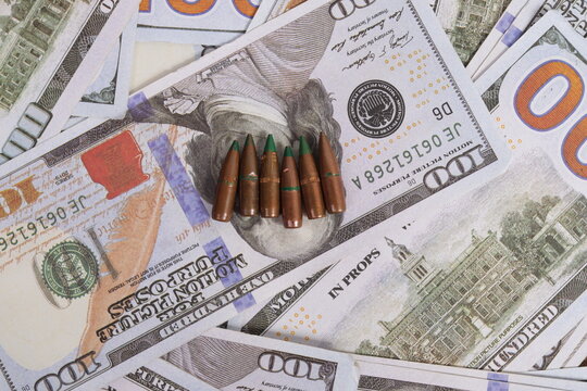 Top View of Metal Rifle Bullets on Scattered US Dollars