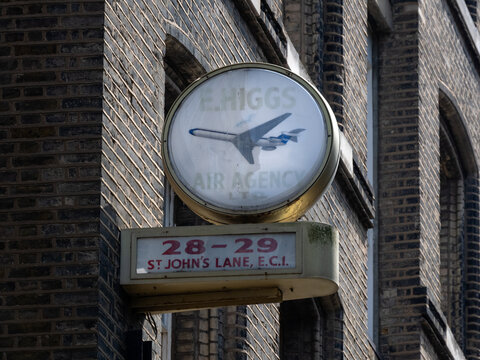 LONDON, UK - JULY 14, 20026:  Old vintage 1960s advertising sign (reverse side of clock) for E Higgs Air Agency in St John's Lane, Farringdon