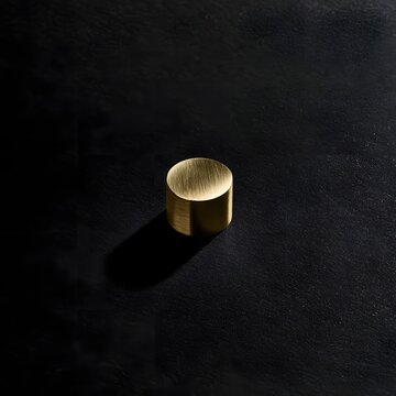 Minimalist Brass Weight on Charcoal Background