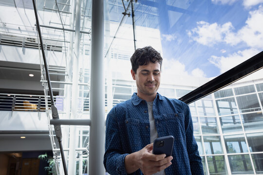 Young man checking phone in an airport