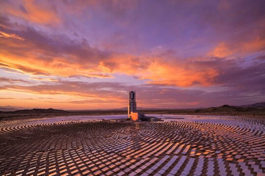 Dramatic Sunset Over a Sandy Beach with Rippled Sand Patterns.