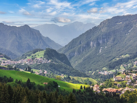 Alpine valley panorama with mountain villages and green meadows in summer, Oltre il Colle, Bergamo, Lombardy, Italy
