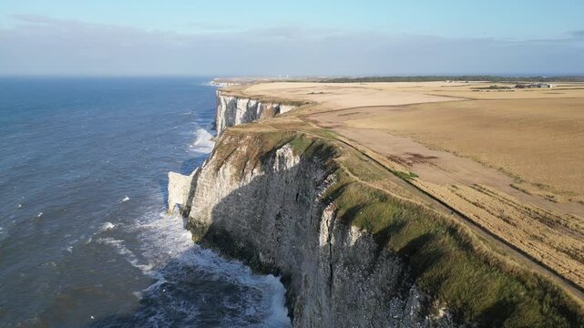 Drone aerial pull back shot of dramatic white chalk cliffs coastline in Yorkshire