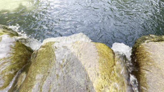 Clear Mountain Stream Flowing Gently Over Sunlit Rocks Landscape