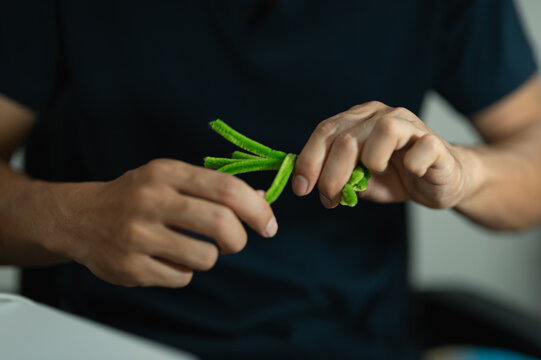 Person Tying Green Childhood Loop Jump Rope During Play or Exercise