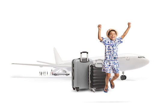 Excited boy traveling with luggage jumping in front of an airplane