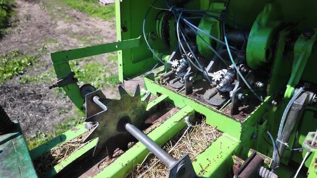 Hay Bale Emerging From Baler With Knotter Mechanism Visible