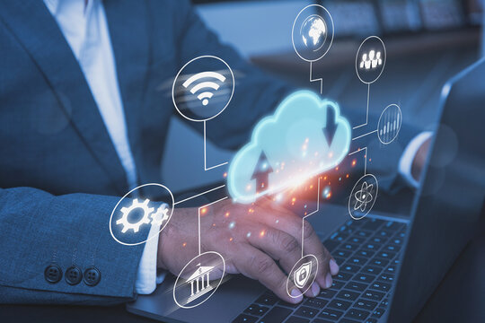 Corporate Businessman Managing Cloud Computing Data and Network Infrastructure on Laptop.