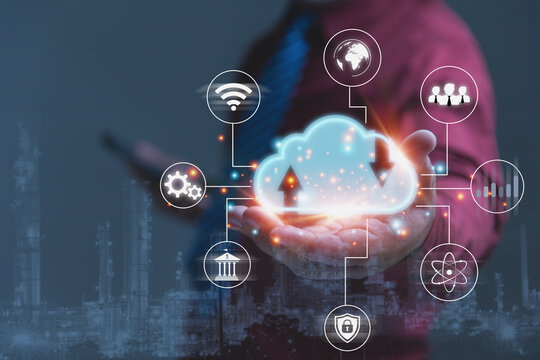 Businessman Holding Glowing Cloud Computing Network Over Industrial City Skyline.