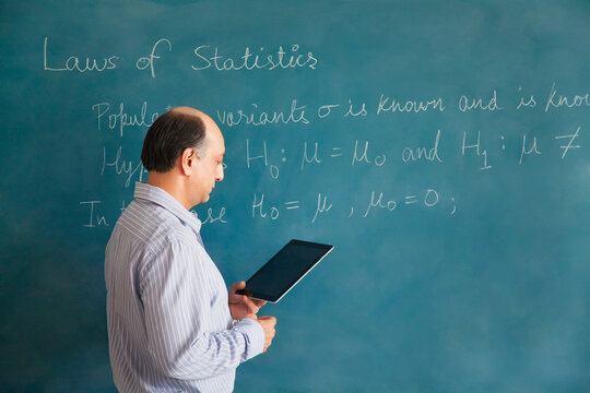 Professor looking at digital tablet