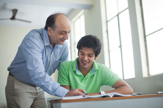Teacher assisting student in classroom