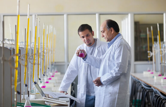 Student watching professor perform experiment