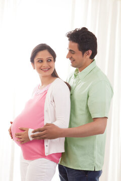 Man embracing pregnant woman